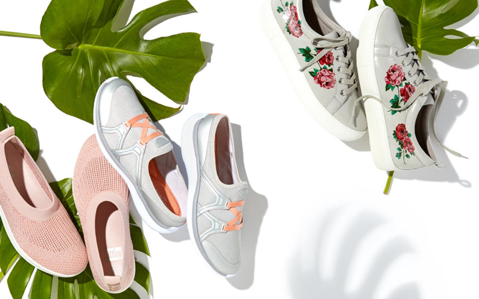 Sneakers and slip-ons dispalyed with tropical leaves