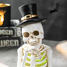 Glitzhome 10.25in. H Halloween Lighted Resin Skull Book Table Decor