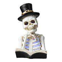 Glitzhome 10.25in. H Halloween Lighted Resin Skull Book Table Decor