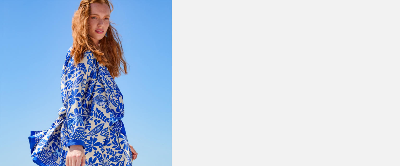 Woman in blue against the sky