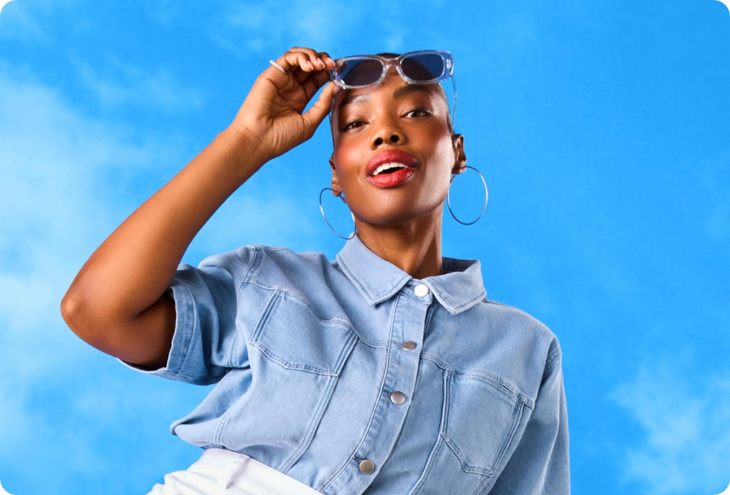 Model with sunglasses against a blue sky